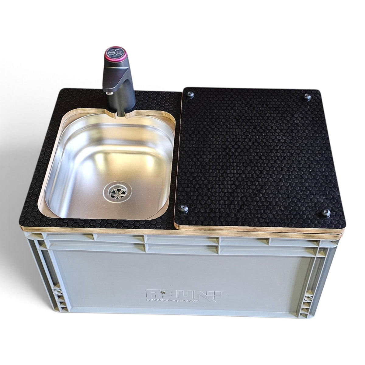 A compact sink countertop unit made from a gray plastic storage crate, featuring a black honeycomb-patterned top panel, a stainless steel sink basin, a black faucet with a pink accent, and a light wood edge trim, shown on a white background.